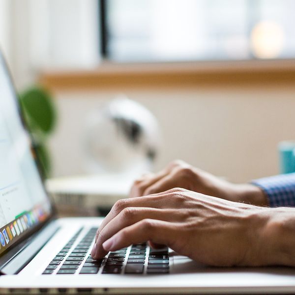 Image of a person typing on a laptop.