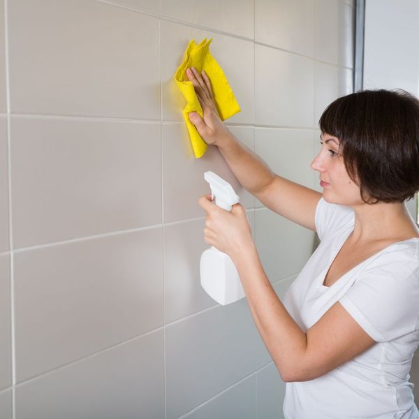 woman cleaning tile