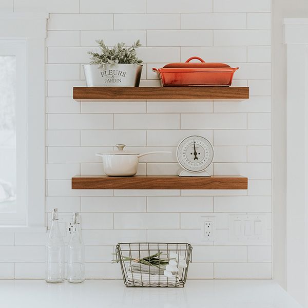 White tile backsplash with wood shelves