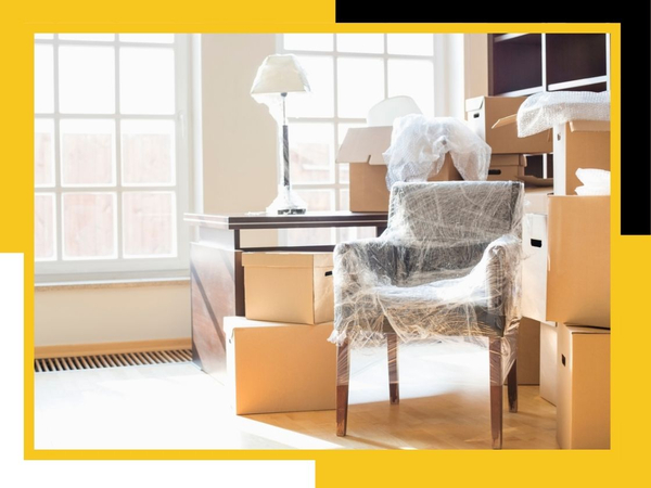 packed boxes and wrapped chair in home office
