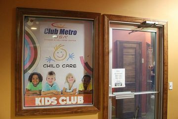 Club Metro USA child care kids' club sign near entrance