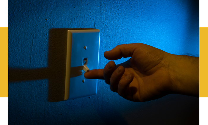 image of someone turning on a light switch