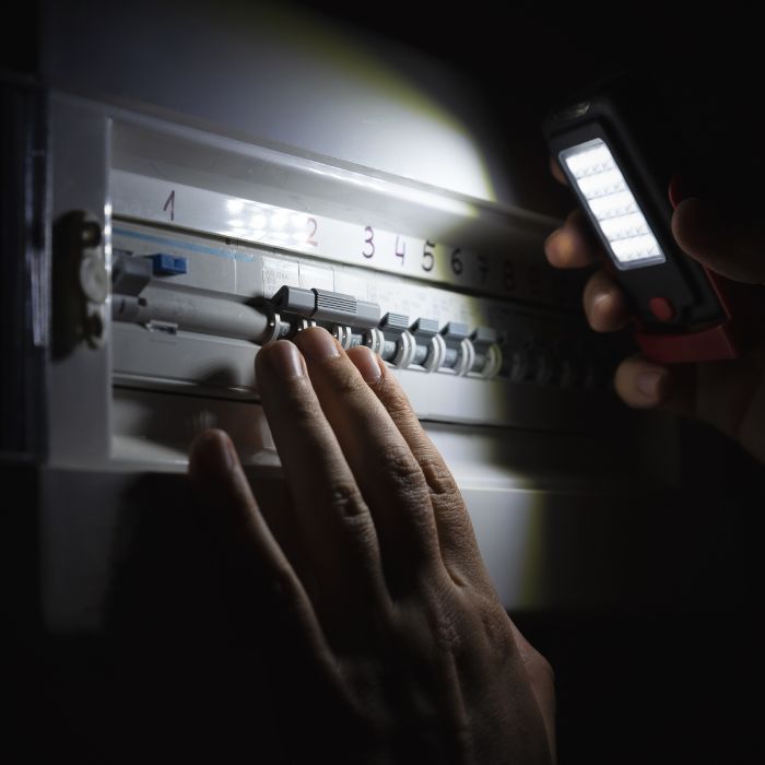 A person inspecting their electrical box