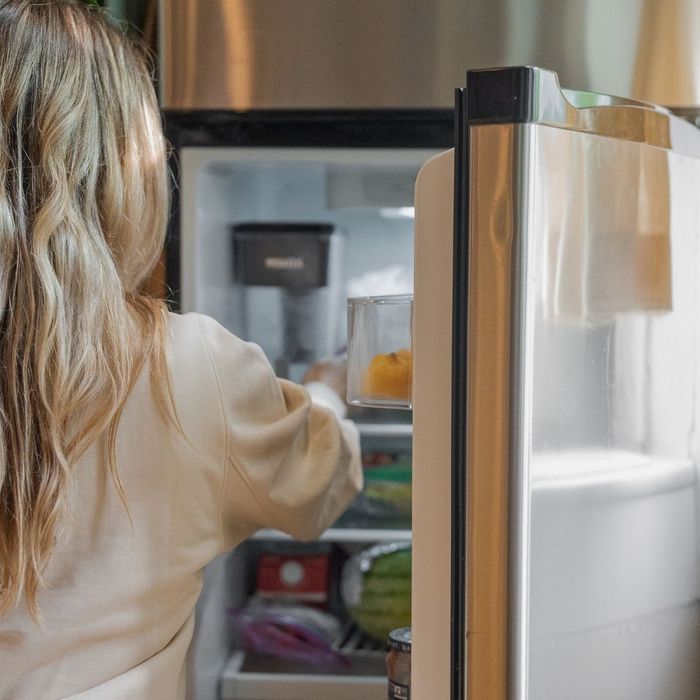 woman opening fridge