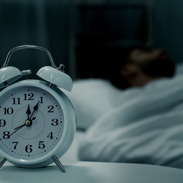 clock near a sleeping man