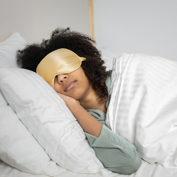 A woman wearing a sleep mask. A woman wearing a sleep mask.