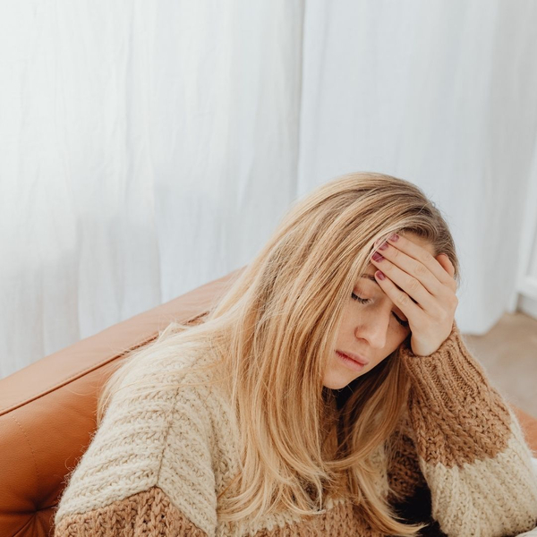 woman with hand on head because of headache 