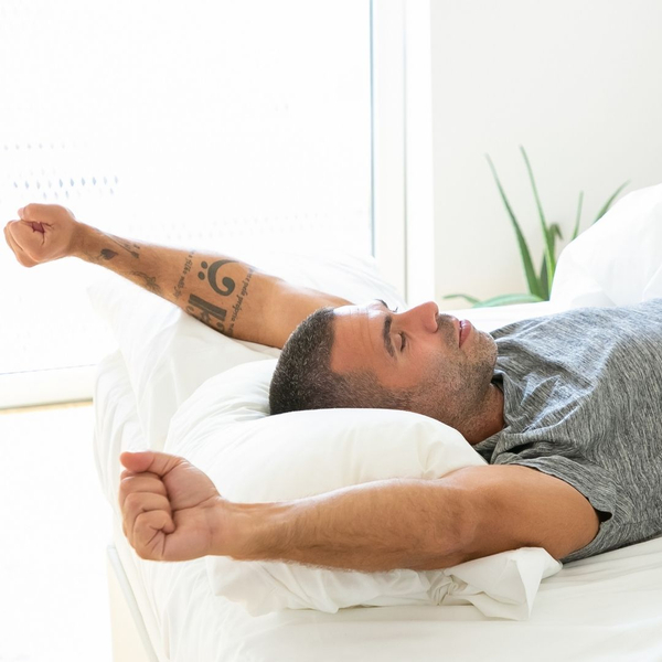 man stretching while waking up