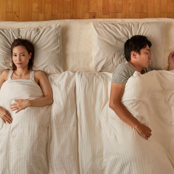 one person sleeping peacefully and one wide awake one person sleeping peacefully and one wide awake