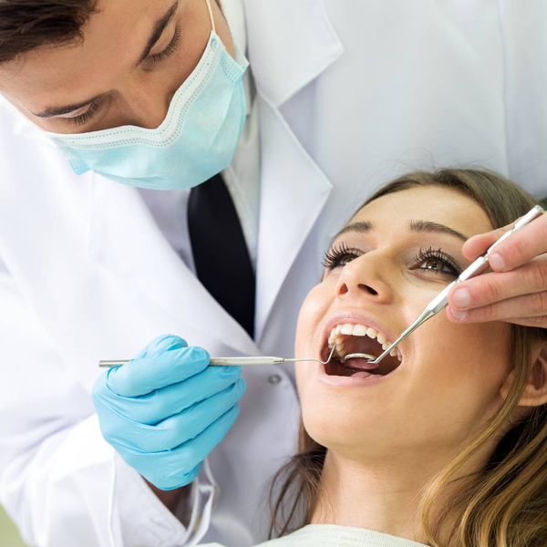 dentist checking patient's mouth
