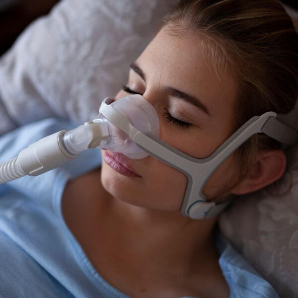 Women sleeping with a CPAP machine