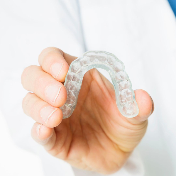 doctor holding an oral appliance