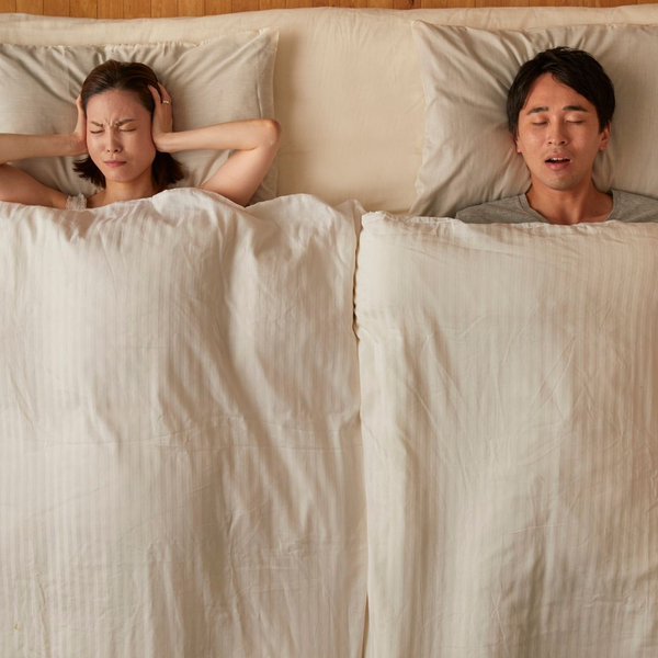 A wife listening to her husband snore. A wife listening to her husband snore.