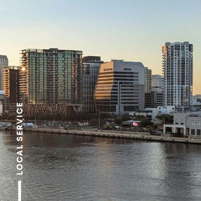 A city skyline next to a body of water at sunset. A city skyline next to a body of water at sunset.