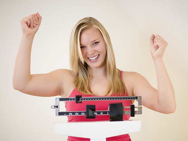 a woman standing on a scale in victory