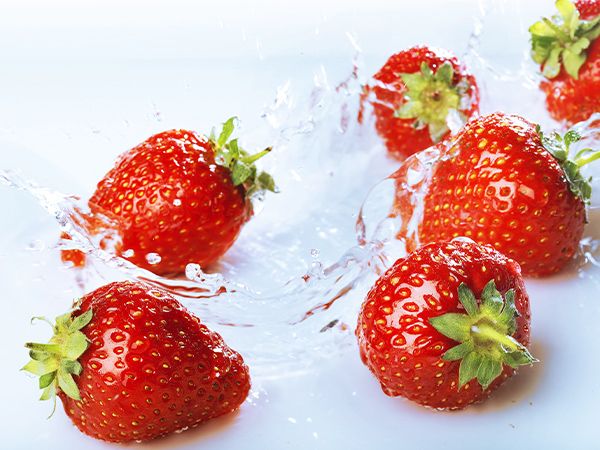 fresh strawberries being splashed with clean water