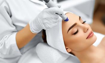 a woman getting a laser facial treatment