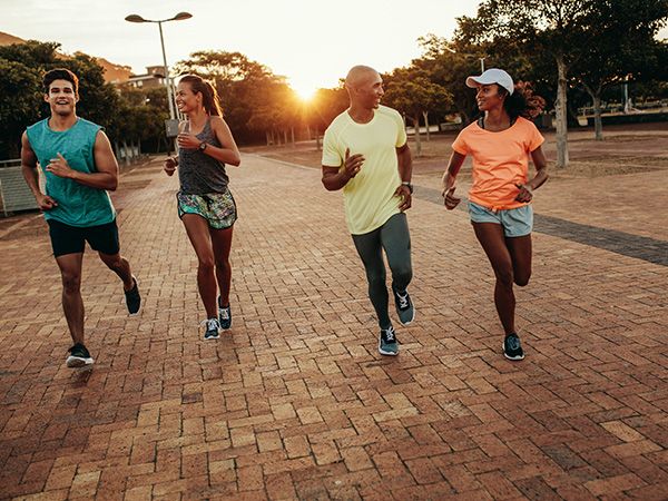 two couples running outside