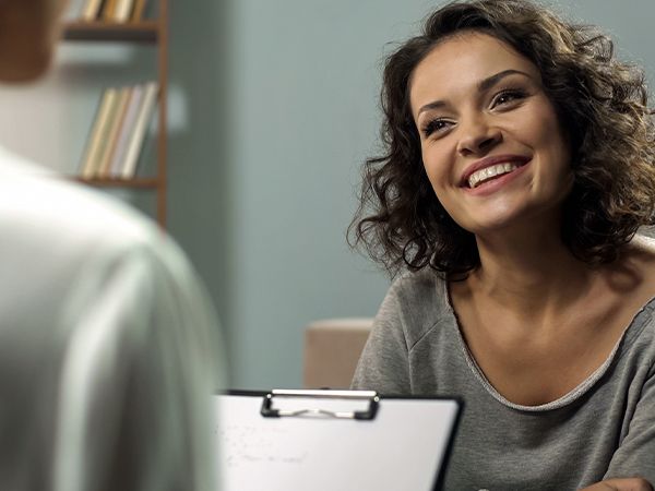 a woman talking to a doctor with a clipboard