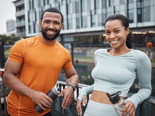 two runners taking a water break