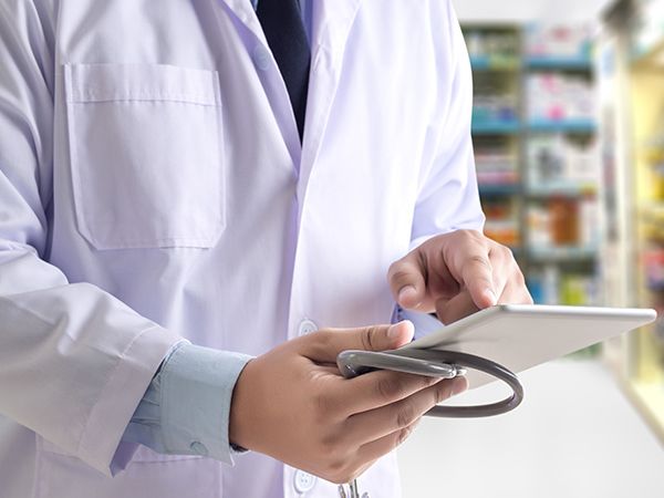 a doctor looking at a tablet