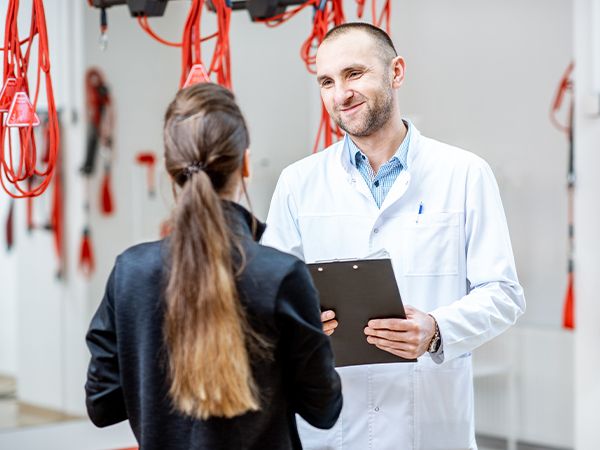 a doctor talking with a patient in an exercise recovery room