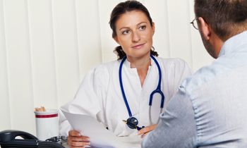 a doctor showing paperwork to a client