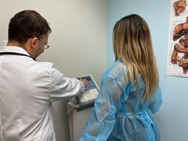 a woman standing on a weight composition machine in an office