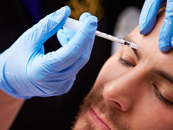 a man getting a Botox forehead injection