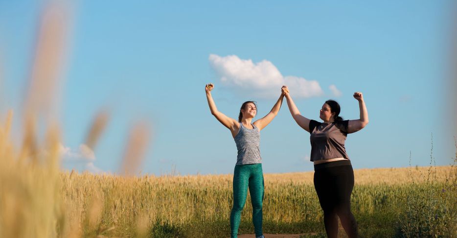 two women rejoicing after working out outside