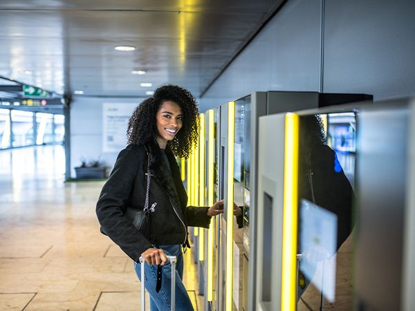 a woman with a travel case in an airport