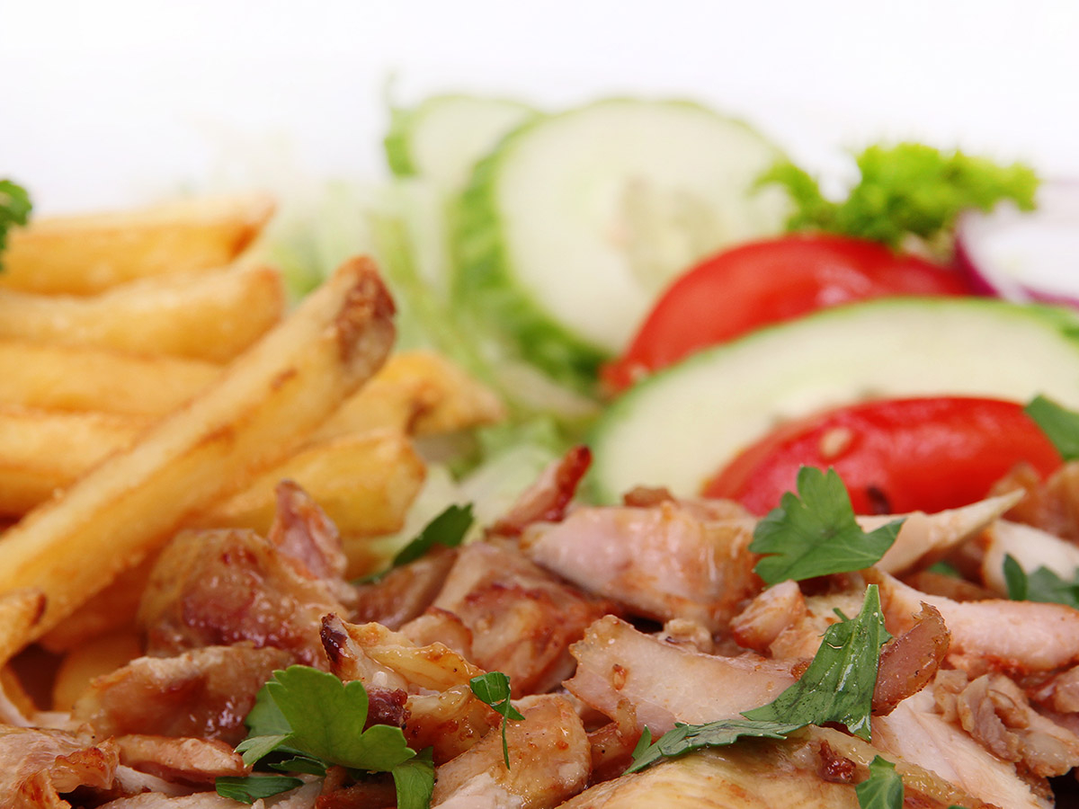  A tangy and delicious gyros plate teeming with delectable meats and fresh vegetables awaits you at Cafe Santorini.