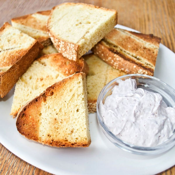 An image of toasted Greek bread with cucumber sauce.