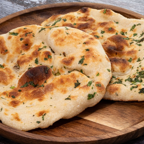 An image of Greek bread with parsley on top.