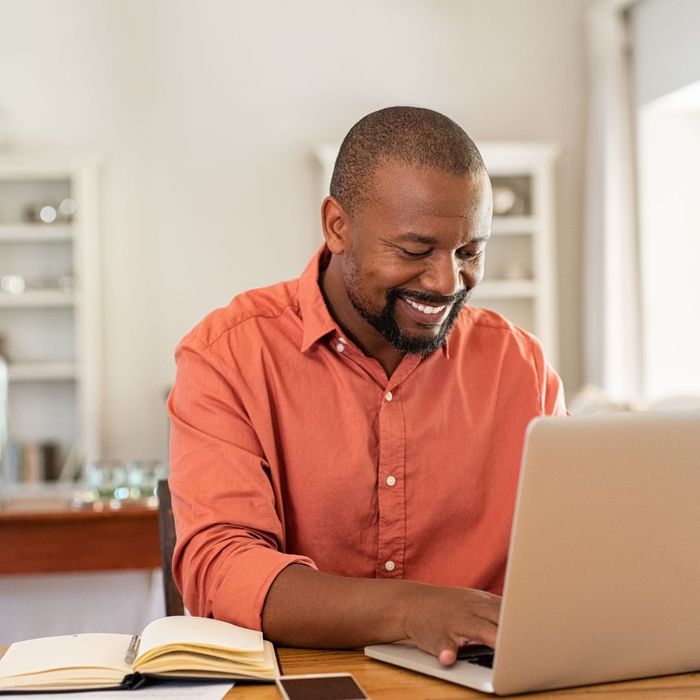 man smiling with laptop