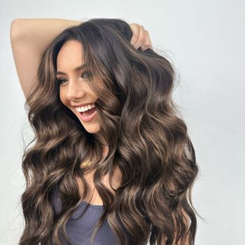 a woman with long hair looking happy