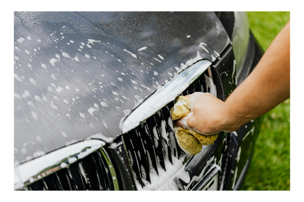 hand washing car with a cloth