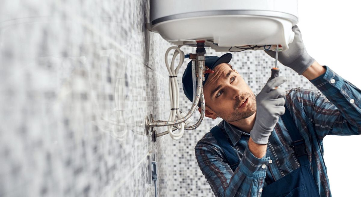 a plumber installing a tankless water heater