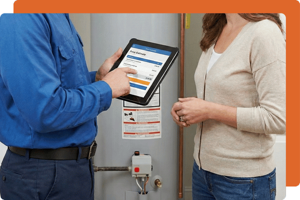 A professional technician in a blue uniform showing water heater service options on a tablet to a customer.