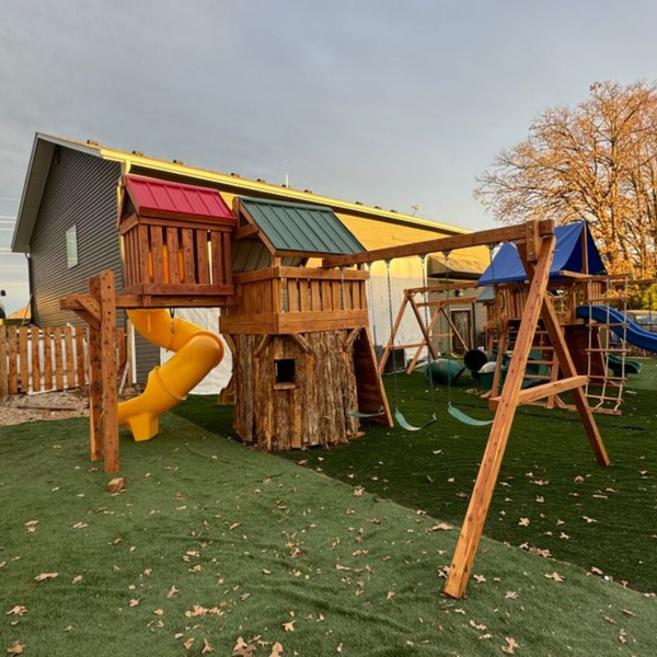 A large playset with swings and a slide