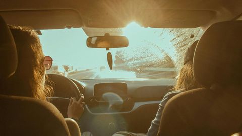 person driving and bright sun