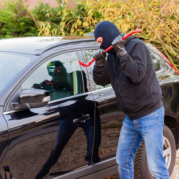 person getting ready to smash a car window person getting ready to smash a car window