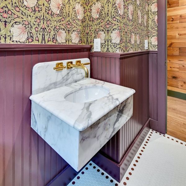 restored bathroom with floral wallpaper